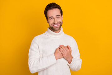 Photo of pretty dreamy guy dressed white sweater arms heart smiling isolated yellow color background