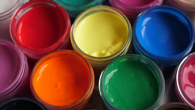 Set Gouache Paints in Jars Bright Color Close Up. Rotation Set of Multicolor Gouache on Plastic Jars. Rotation Multicolor Background. Background of Multi Colored Paint. Creative Drawing Art Hobby.