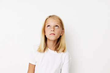 emotional girl in a white t-shirt grimace kids lifestyle concept