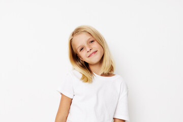Obraz premium Positive little girl with blond hair on a light background