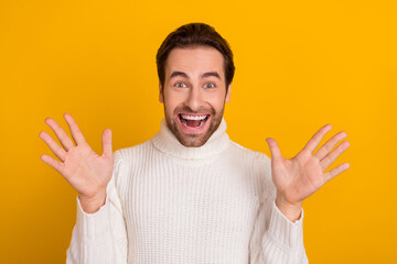 Photo of crazy shocked guy raise hands rejoice exciting promotion news wear white sweater isolated...