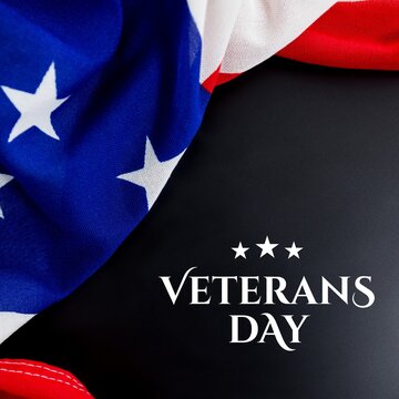 Composition of veterans day text with flag of united states of america