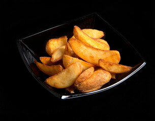 fried french fries on a black background