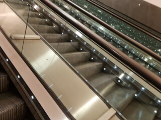 moving escalator in airport. Macro view of escalator in a subway station. People like travel with comfort. Beautiful interior with modern technology. Industrial background for creative design layout.