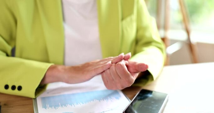 Businesswoman counting and curling fingers at office table closeup 4k movie slow motion