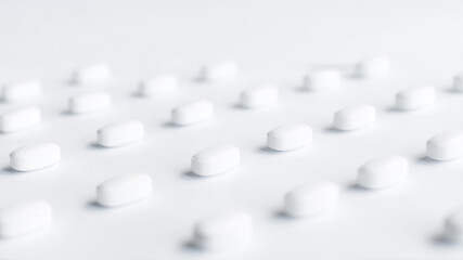 white pills on a white background. Model special offers as advertising, web background or other ideas. The concept of medicine, pharmacy and healthcare. Copy space. Empty space for text or logo