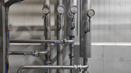 Industrial background of stainless steel pipes and gauges in production room of factory