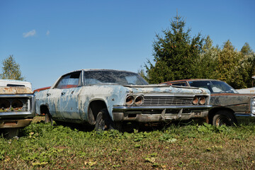 Concept of outdated equipment and transport. Abandoned not needed. Russia, Moscow - September 2022. Old rusty Chevrolet Impala standing outside at exhibition or dump. Rotted from old age and time.