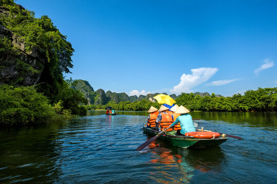 A rowing boat carrying tourists on the river in Trang An, Ninh Binh province, Vietnam. Trang An is a world cultural and natural heritage recognized by UNESCO	