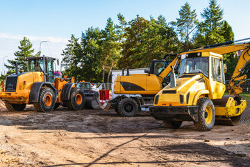Obraz na płótnie Canvas Heavy industrial machinery at construction site parking area