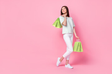 Full size photo of gorgeous nice girl wear striped t-shirt white pants shoes hold bags look empty...