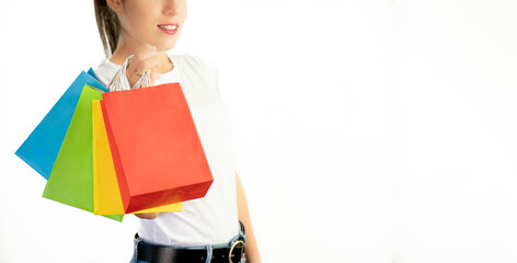 Unrecognizable young woman holding colorful bags on white background with copy space - shopping concept, sales, black friday, christmas