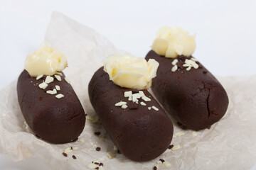 Cake potato. Decorated with butter cream. On a white background. Shot close-up.
