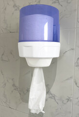 Soft focus tissues paper towel dispenser on bathroom wall
