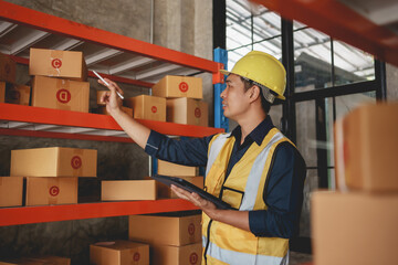 Asian male supervisor worker inspecting warehouse checking stock, counting inventory and inspecting the product to check the quality.