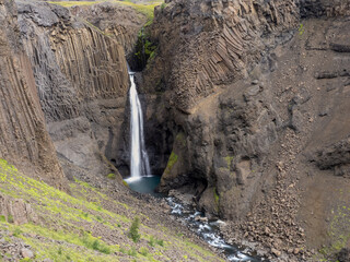 Litlanesfoss waterfall down the Hengifossá river Hengifoss waterfall, notable by its jointed...