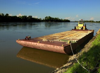 Rusty old barge tied to the bank of the Missouri River