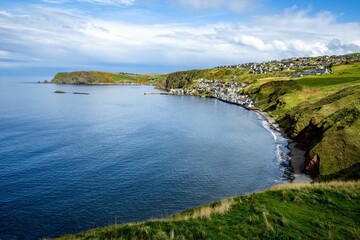 The picturesque village of Gardenstown, Scotland on the northern coast of the UK with blue skies