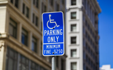 Traffic sign saying that parking is allowed only for people with disabilities. Transportation...