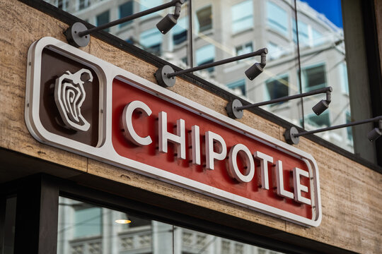 The logo sign of a Chipotle fast casual restaurants with Mexican grill food in San Francisco, 2022.