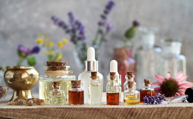 Essential oil bottles with frankincense, echinacea and lavender flowers