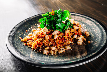 Fried rice with chicken and vegetables in plate on wooden table background