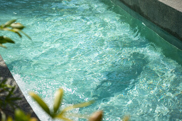 Clearly transparent turquoise water swimming pool at the water park. Recreation place for...
