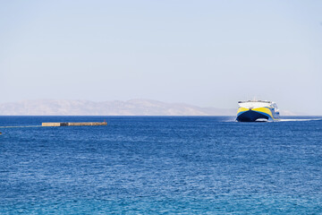 Ferry boat destination Greece, Naxos harbor Cyclades islands. High speed vessel in vast Aegean sea.