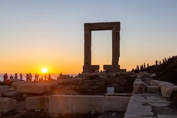 Naxos island, sunset over Temple of Apollo, Cyclades Greece. People enjoys the sundown background.