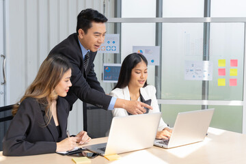 A group of young Asian businessmen Talking and planning work happily and have fun. at the company's office