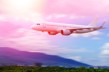 Commercial airplane above in summer season and blue sky over beautiful scenery nature background,concept business travel and transportation summer vacation travel.