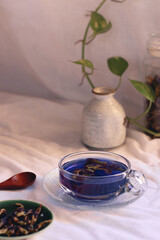 A cup of antioxidant rich herbal blue butterfly pea tea for a relaxing autumn afternoon 