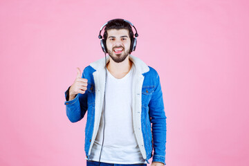 Dj with headphones showing thumb up