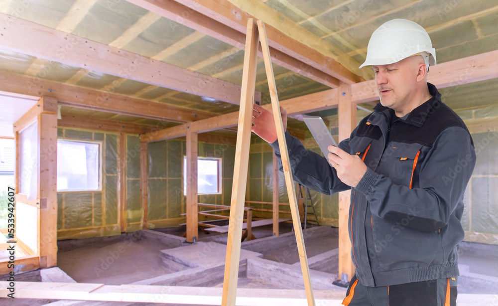 Aufkleber builder inside building. man builder with boards and tablet. decorating house with wood. tablet in h