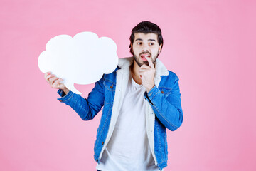 Man with a cloud shape thinkboard looks thoughtful and dissatisfied