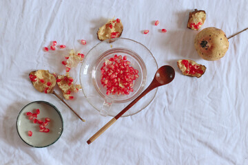 Top view of deseeded pomegranate fruit in order to make natural and healthy juice showing the autumn aesthetic