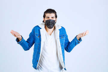 Man in black mask looks confused and trying to explain himself