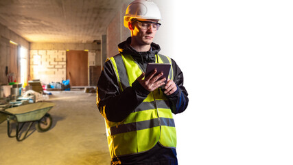 Builder man with tablet. Engineer with electronic tablet. Man in builders uniform. Guy builder in...