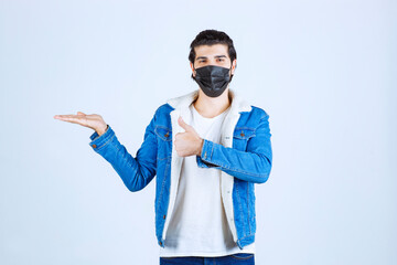 Man in black mask showing enjoyment sign and feeling good