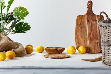 Lemons on a wooden table in a white kitchen interior on a beautiful summer day and free space