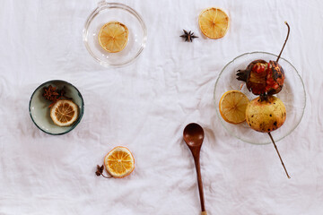 Overhead view of pomegranate fruit and dried lemon slices for making fresh juice, showing an autumn theme aesthetic background
