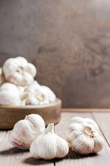 Garlic bulbs on a wooden background. Copy space.
