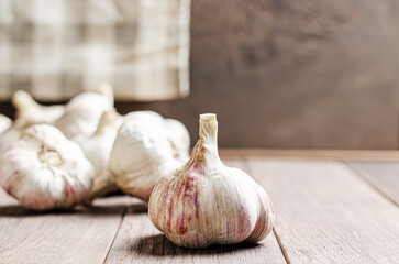 Garlic bulbs on a wooden background. Copy space.