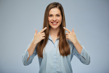 Smiling woman pointing at teeth.