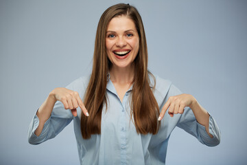 Smiling woman pointing finger down.