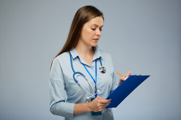 Doctor woman or health Insurance agent writes on blue clipboard. Isolated portrait of female medical worker