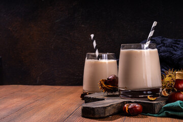 Chestnut smoothie. Autumn spicy creamy drink with whipped roasted chestnuts, cinnamon, spices, on wooden rustic background copy space