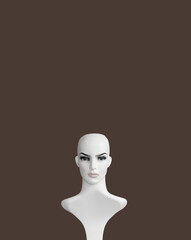 White plastic female mannequin  portrait on brown color background