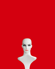 White plastic female mannequin  portrait on red color background