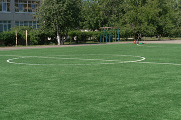 Fototapeta premium Marking on a modern stadium with artificial turf. School stadium.